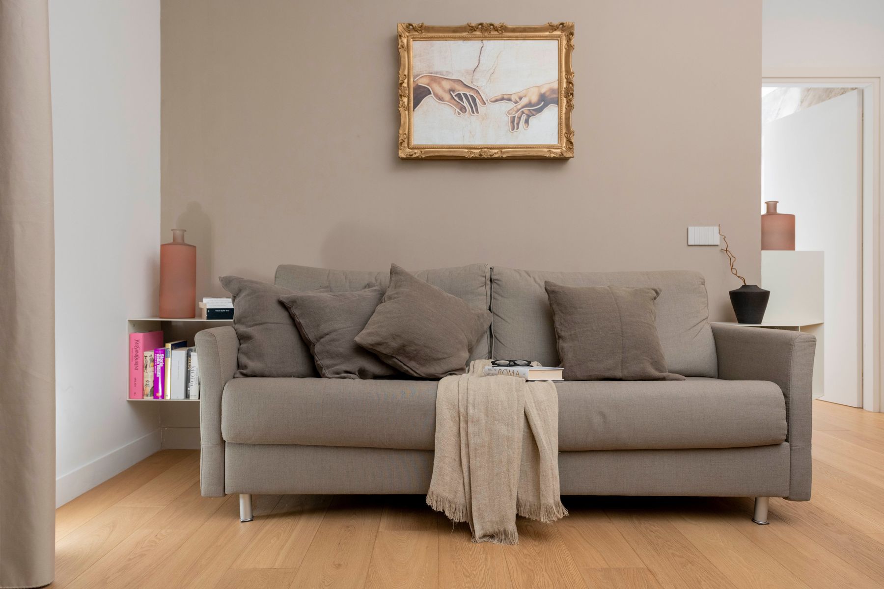 Living room sofa beneath a gilded artwork